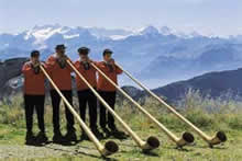 horn players in traditional costume